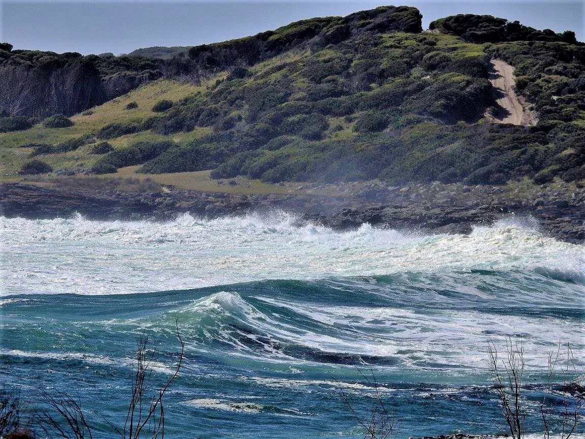 Surf breaking below the headland at Granville Harbour, West Coast Tasmania