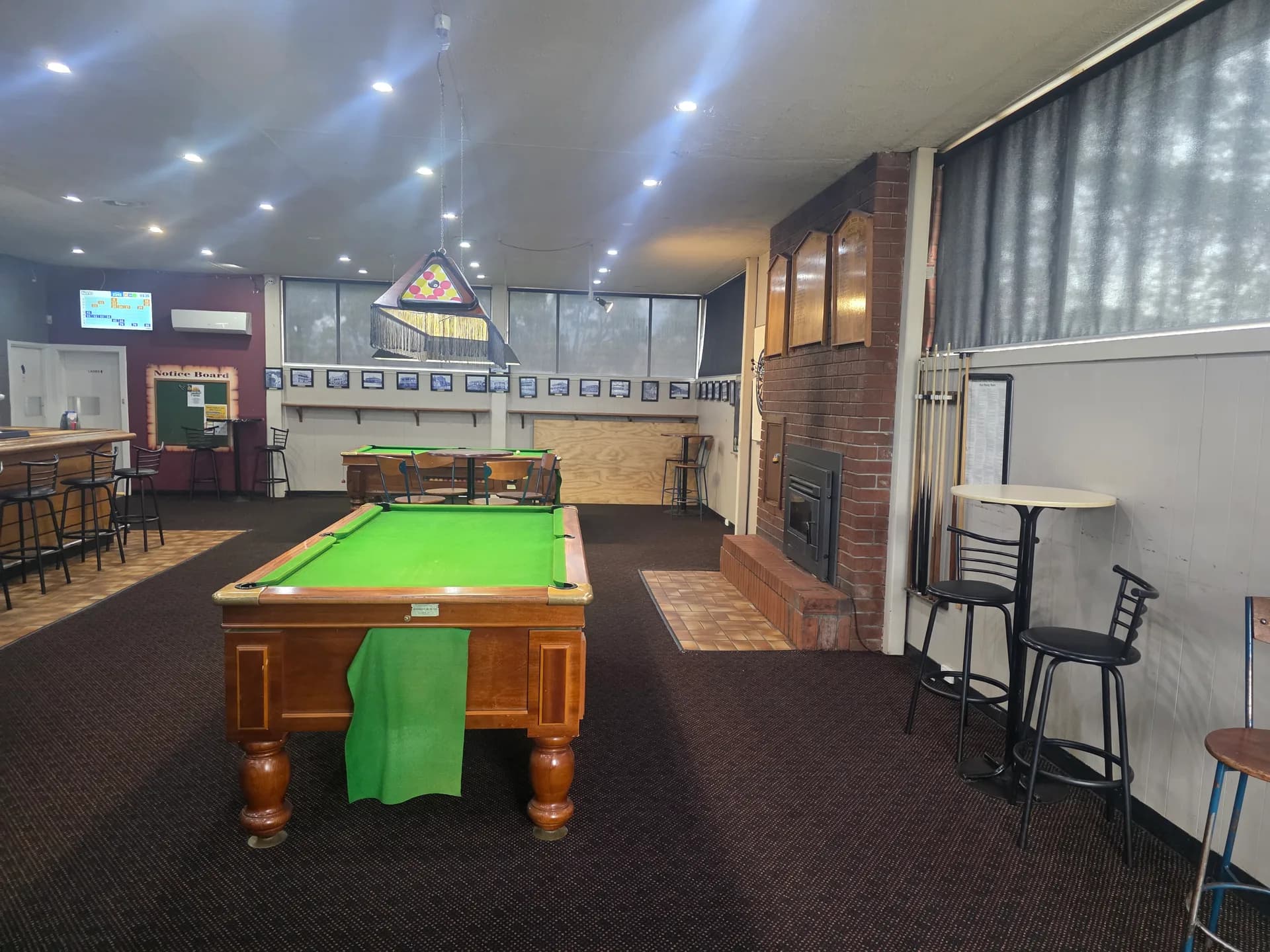 Pool table, log fire and honour boards in the public bar at the Heemskirk Motor Hotel, Zeehan